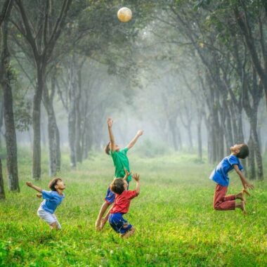 Kids playing in the park between trees in Minsk