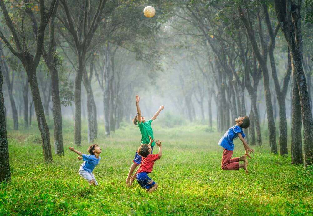 Kids playing in the park between trees in Minsk