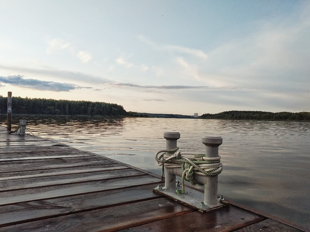 Minsk sea shore with wooden pathway during sunset, Belarus